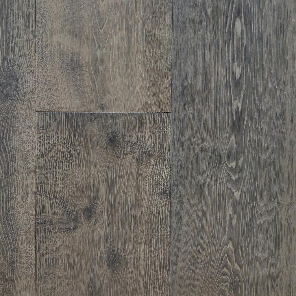 Dark gray wooden flooring planks with real grain patterns, knots, and weathered textures. Engineered European Oak Wide Plank Baronial Dusk Flooring is the product shown. 