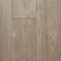 Light oak wood flooring planks with visible grain patterns and natural knots in a warm grayish-brown tone. The flooring in this image is Engineered European Oak Wide Plank Flooring Ember Valley.