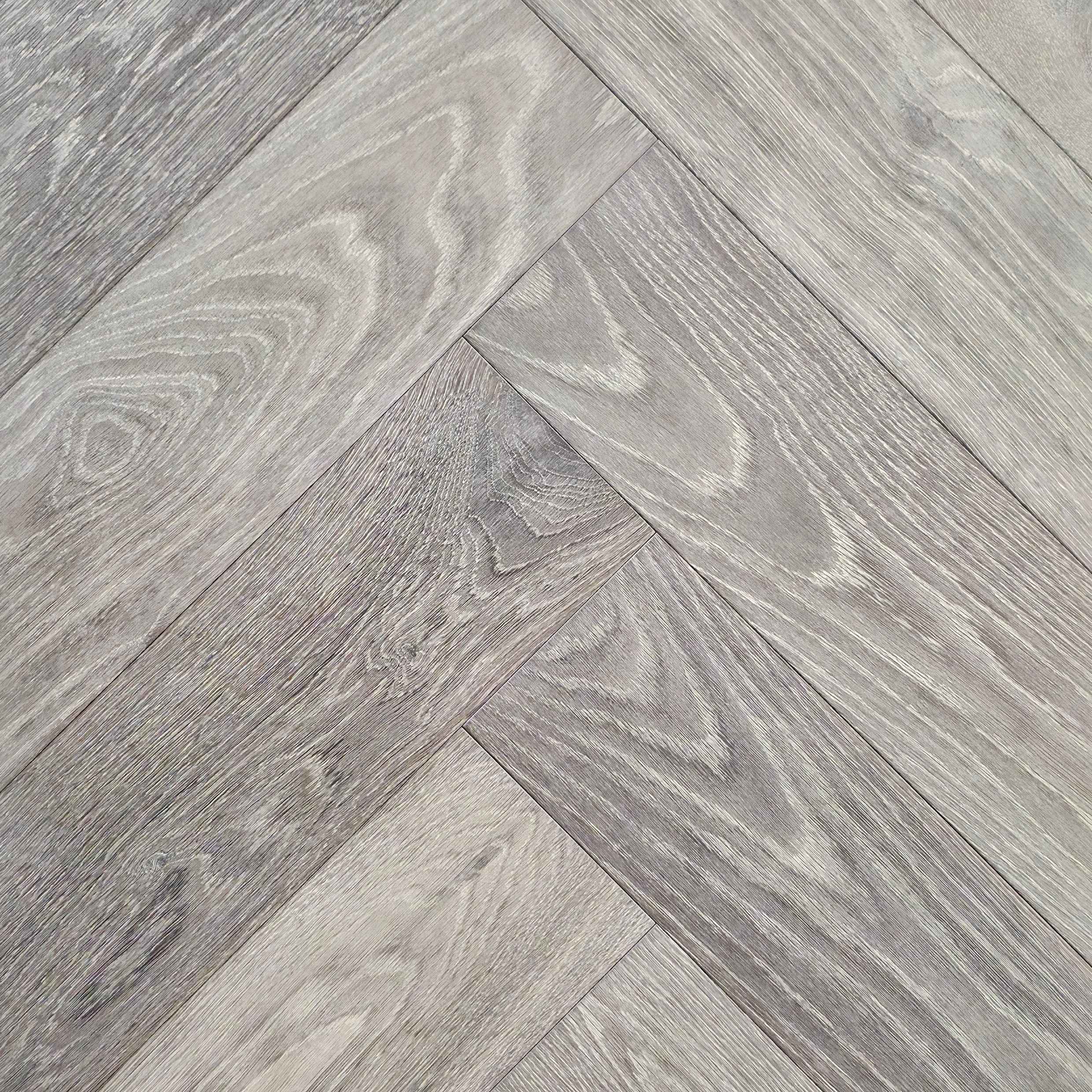 Close up of Luxe Timberline engineered european oak herringbone flooring.