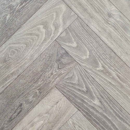 Close up of Luxe Timberline engineered european oak herringbone flooring.