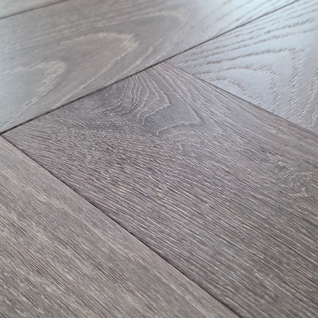 Close up of Luxe Timberline engineered european oak herringbone flooring.