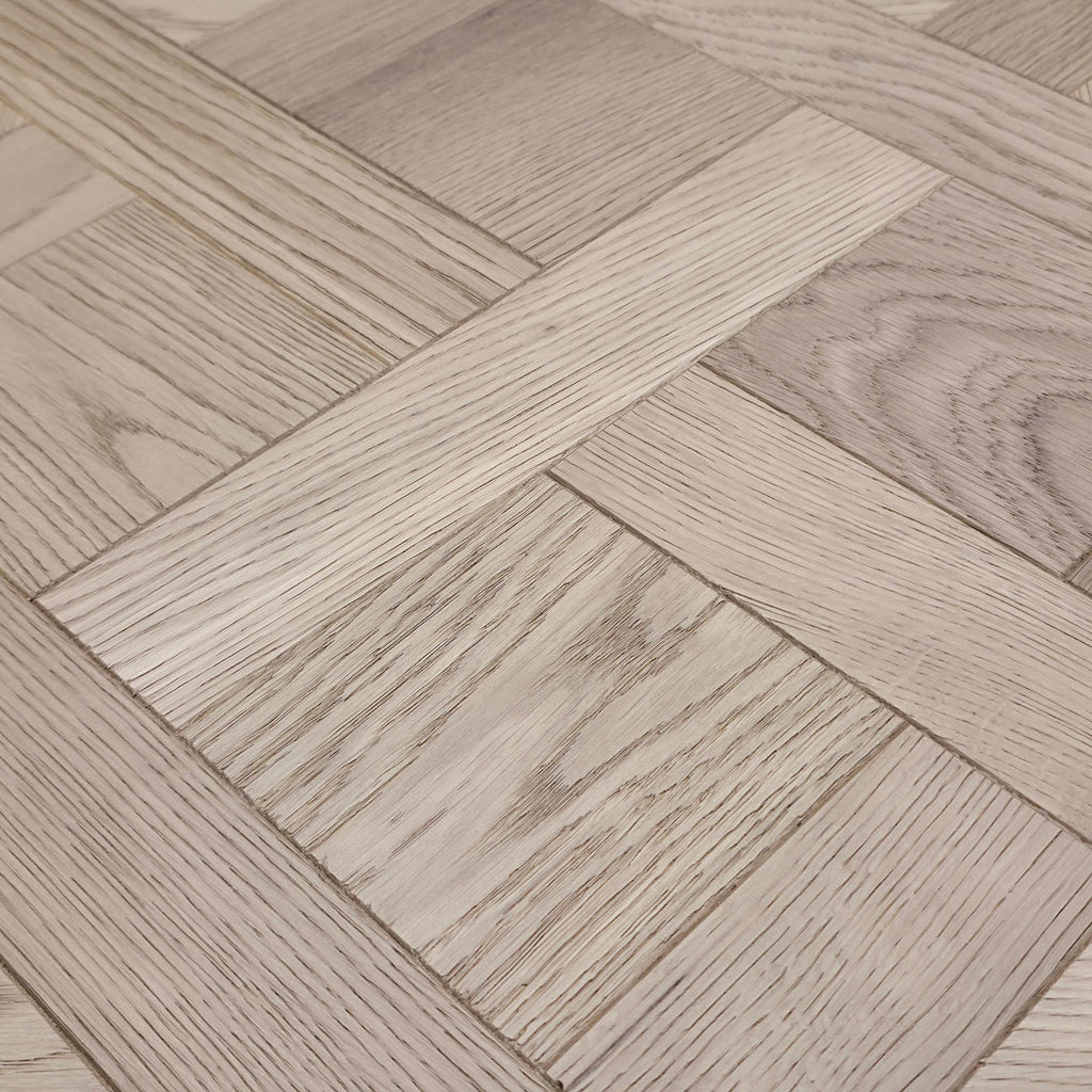 Light oak wood parquet flooring tiles arranged in a basketweave pattern, showing natural wood grain textures.
Engineered European Oak Nouveau Manoir - Parquet is the flooring shown.