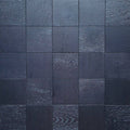 Dark charcoal gray square tile mosaic wall or floor with a subtle woodgrain. Engineered European Oak Ombre Royale - Parquet 