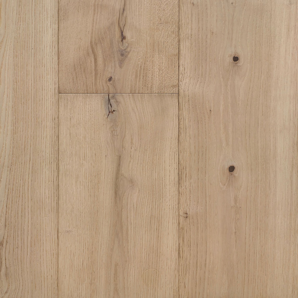 Light natural oak wood flooring planks with visible grain, knots, and subtle seams between panels. Engineered European Oak Verbier Bare wide plank  shown.