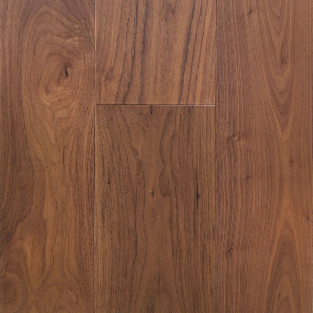 Medium brown Walnut wood flooring planks with prominent grain patterns and natural knots. Photo is of Velours Noyer - Wide Plank.