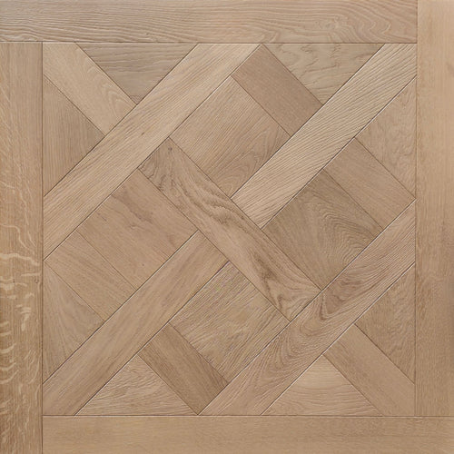 Light oak wood parquet flooring with a geometric herringbone and diamond pattern, featuring a matching solid wood border. Shown is  a single engineered European oak Gstaad Glow Parquet Tile.