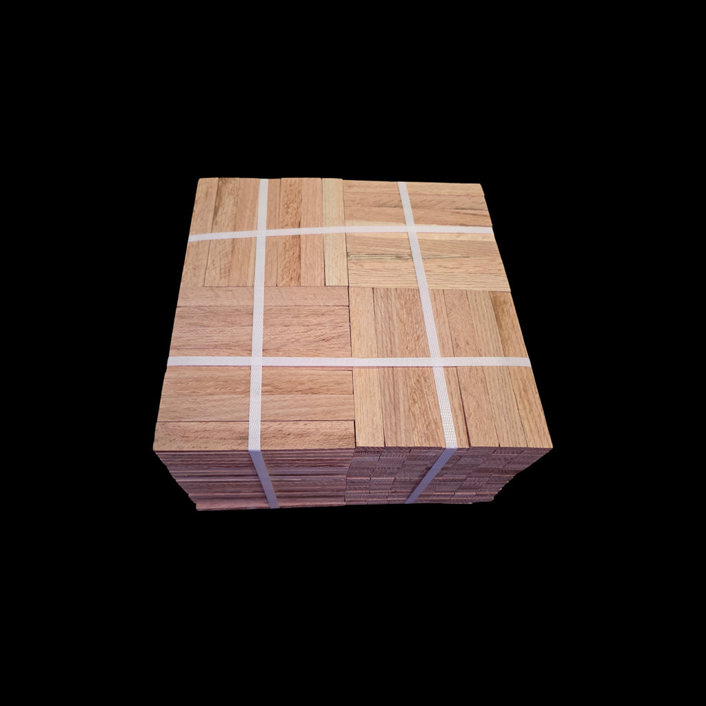 Unfinished Red Oak Parquet - 7 Fingers - 12" x 12" x 5/16" - Full Box Shown as 20 tiles stacked on top of each other. The tiles are being held together by 4 intersecting bands. Under the Bundle is a black cloth. 