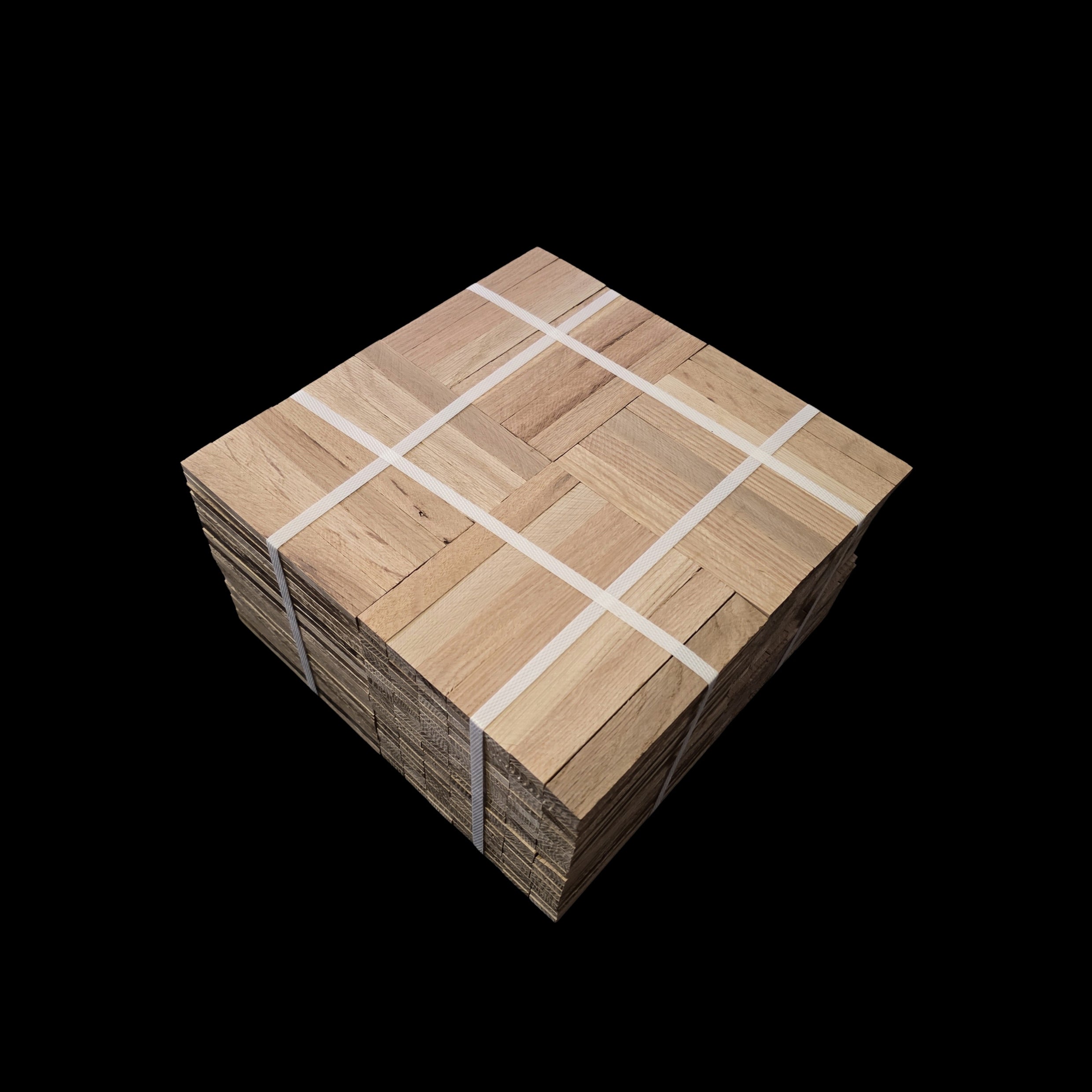 Unfinished Red Oak Parquet - 7 Fingers - 12" x 12" x 5/16" - Full Box Shown as 20 tiles stacked on top of each other. The tiles are being held together by 4 intersecting bands. Under the Bundle is a black cloth. 