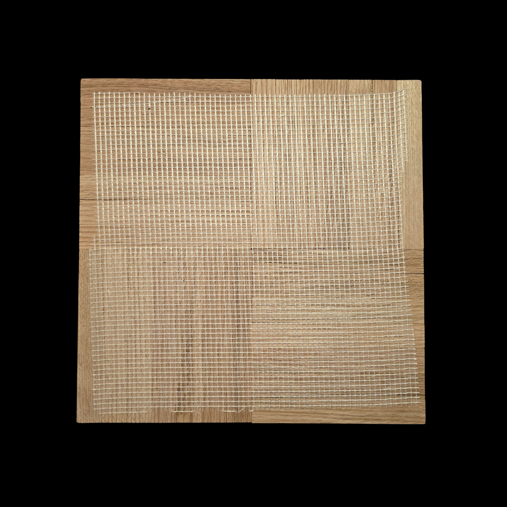 Unfinished Red Oak Parquet - 7 Fingers - 12" x 12" x 5/16" - Single Tile, shown close up with a black fabric background. This image shows the backside of the tile. With a webbed backing.