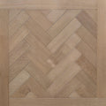 Light oak wood flooring shown in a herringbone parquet pattern with a matching wood trim border. engineered European oak hearthside Oak parquet is shown.